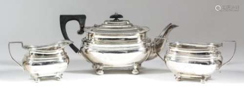 A George V silver rectangular three-piece tea service with gadroon mounts, moulded bulbous bodies,