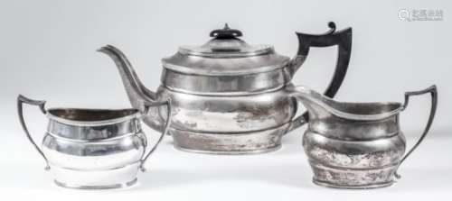 A George V silver oval three-piece tea service with reeded mounts and angular handles,
