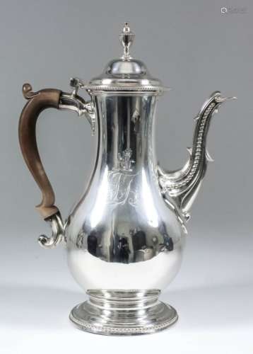 A George III silver bulbous coffee pot, the domed lid with urn finial and bead mounts to rim, cast