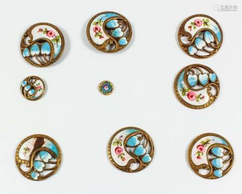 Seven French gilt metal and enamel circular buttons pierced and cast with stylised flowers and