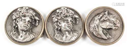 Two brass mounted and silver plated circular dress studs cast with the bust of a young woman, one