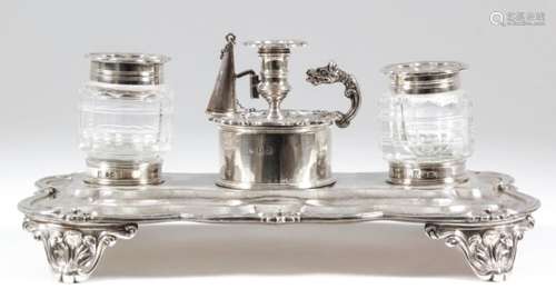 A William IV silver rectangular inkstand of shaped and moulded outline with leaf and floral mount to