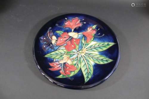 LARGE MOORCROFT WALL PLATE in the Simeon design, the flowers painted on a blue ground. Designed by