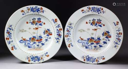 A pair of Chinese porcelain chargers enamelled in blue, red and gilt with exotic birds on