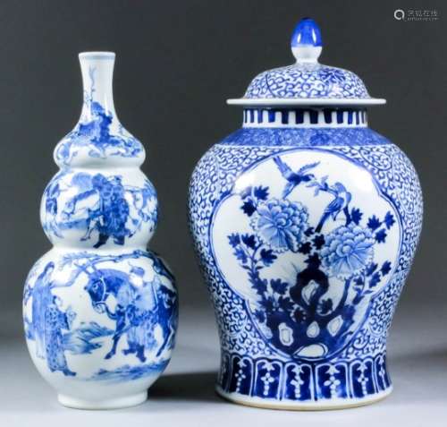 A Chinese blue and white porcelain baluster-shaped vase and cover, painted with reserves of