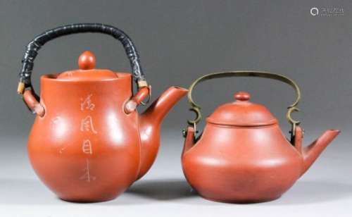 Two Chinese Yixing red stoneware teapots and covers of circular form with brass swing handle, 3.