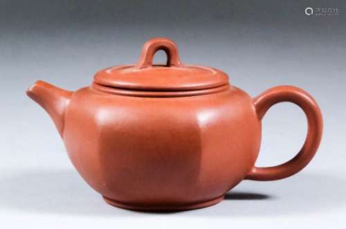 A Chinese Yixing red stoneware teapot and cover of compressed form, 2.75ins (7cm) high, with