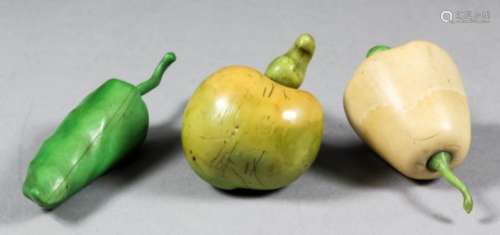Three Japanese carved ivory and green stained okimono depicting exotic fruit and peppers, 3.5ins (