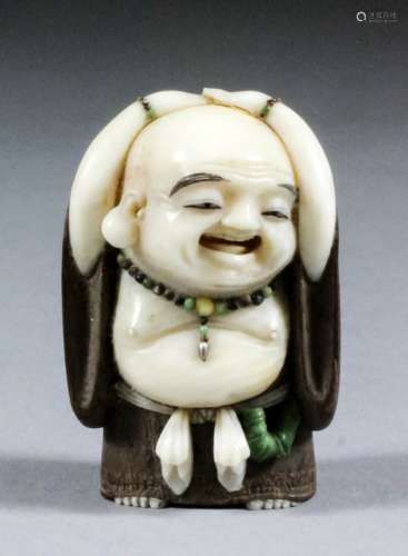 A Japanese carved ivory and wood netsuke of a standing Hotei, by Akishige, wearing a beaded necklace