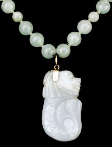 A Chinese pale celadon 650mm bead necklace with various sized beads and with small carved dragon