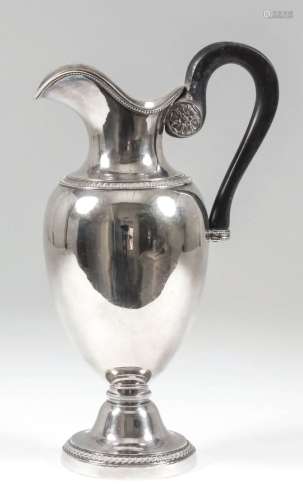 An early 19th Century French silver jug with plain urn shaped body, bead and acanthus mounts to rims
