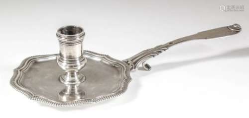 A French Louis XV silvery metal chamber candlestick, the shaped sexfoil dish with gadroon mounts