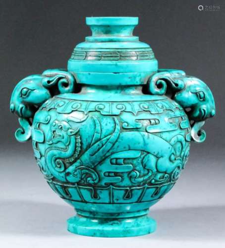 A modern Chinese two-handled turquoise vase and cover of archaic form, carved in relief with
