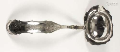 A late 19th/early 20th Century Dutch silvery metal oval punch ladle, the shaped bowl and curved