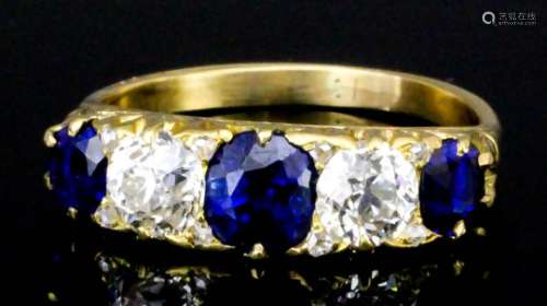 A modern 18ct gold mounted sapphire and diamond five stone ring, set with three oval cut