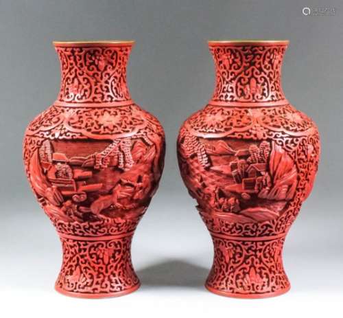 A pair of Chinese cinnabar lacquer vases of baluster shape, deeply carved with figures in