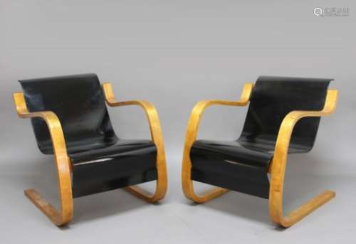 PAIR OF ALVAR AALTO ARMCHAIRS a pair of Model 31 laminated cantilever wooden armchairs, with