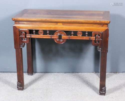 A Chinese hardwood rectangular side table with flush panelled top, frieze fretted and carved with