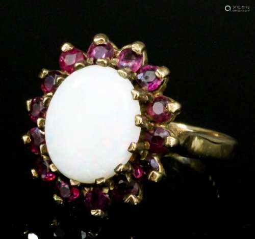A modern 9ct gold mounted opal and red spinel ring, set with central oval opal, 10mm x 8mm,