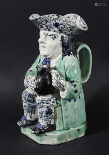 PEARLWARE TOBY JUG, circa 1800, the seated toby holding a jug, blue sponged tricorn hat and trousers