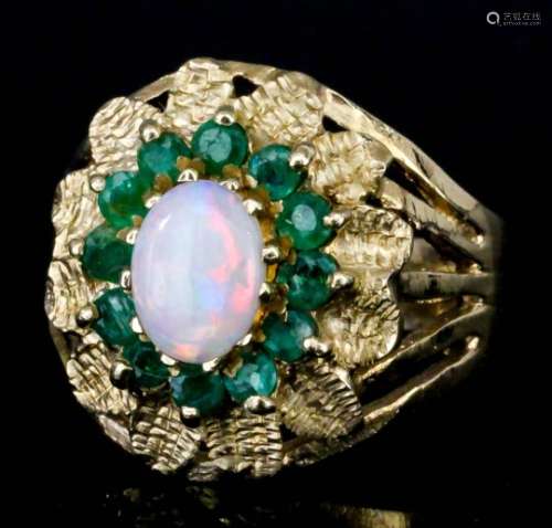 A modern 9ct gold mounted opal and emerald ring, set with central oval opal, 5mm x 7mm, surrounded