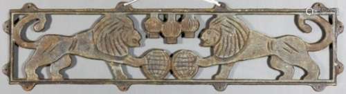 A cast iron wall mount cast with two lions with paws on two globes, below three lanterns, 47ins x