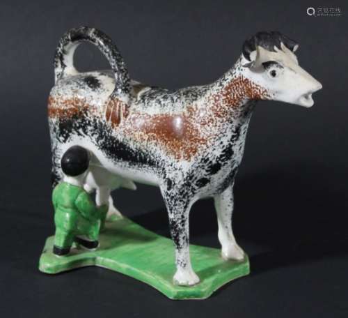 PEARLWARE COW CREAMER, circa 1800, Yorkshire or Newcastle, with black and brown sponged decoration