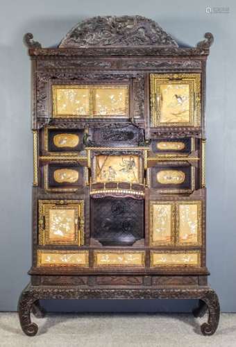 A good Japanese dark stained wood, gilded and lacquer display cabinet of shaped and tiered
