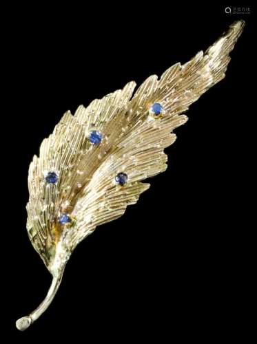 A modern 18ct gold mounted and sapphire brooch of leaf pattern, set with five small sapphires,