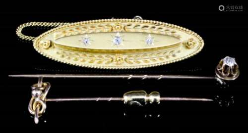 A 15ct gold and gem set oval brooch, set with three central white stones in star mount and with