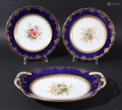 COALPORT DESSERT SERVICE, early 20th century, painted with floral sprays inside a blue and gilt