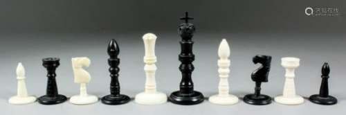 A late 19th Century turned and carved natural ivory and black stained ivory chess set, Kings 3.75ins