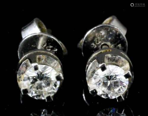 A pair of 18ct white gold mounted solitaire diamond stud earrings (for pierced ears), set with round