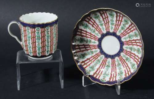 WORCESTER FLUTED COFFEE CUP AND SAUCER, circa 1760, over glaze painted with a trellis pattern in