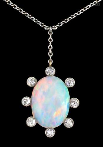 An early 20th Century 18ct white and yellow gold mounted opal and diamond oval pendant, set with