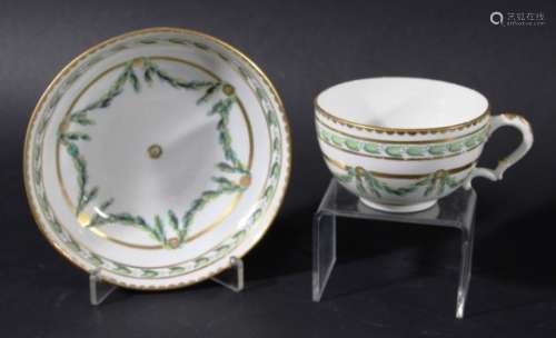 BRISTOL TEACUP AND SAUCER, circa 1760, painted with floral swags in shades of green with gilt