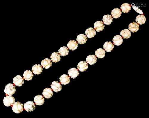 An early 20th Century single strand of thirty Oriental ivory beads, each carved with a melee of mice