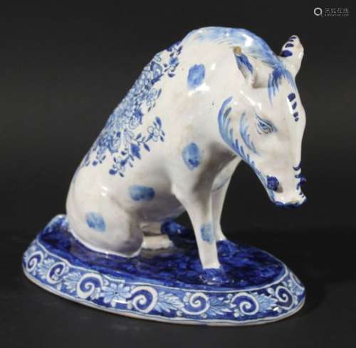 FRENCH FAIENCE BOAR, 19th century, modelled seated, with blue floral decoration, blue AK 61 to the