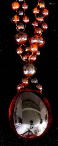 A single strand of Baltic amber beads with variously sized beads and with plain polished amber egg