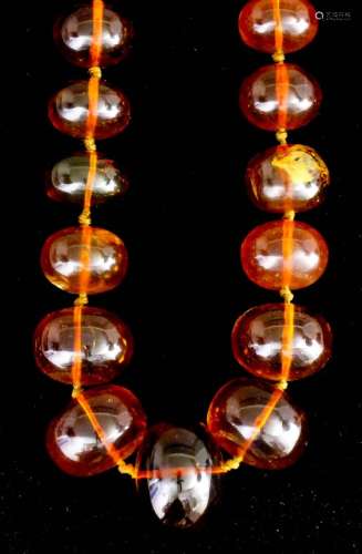 A single strand of forty-eight European reconstituted amber beads, 690mm overall (weight 120