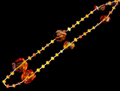 A single strand of European reconstituted amber beads, comprising - seven large geometric beads