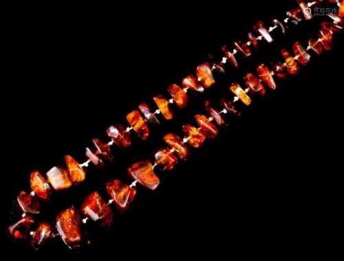 A single strand of seventy European reconstituted amber beads, 720mm overall (gross weight 86