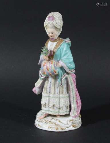 MEISSEN FIGURE OF A LADY, 19th century, standing holding a posy of flowers and a muff, blue