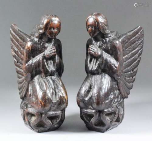 A pair of Continental carved oak angels kneeling in supplication, 9ins high