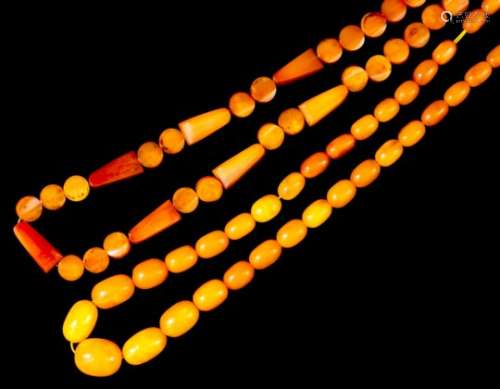 A single strand of forty-six reconstituted butterscotch amber beads of circular flat form, seven