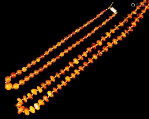 A single strand of ninety-two reconstituted amber beads, 820mm overall, and a single strand of fifty