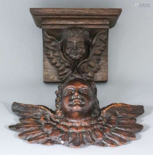 A French stained pine carved head of a winged putto, 15ins wide x 9.25ins high, and an oak bracket