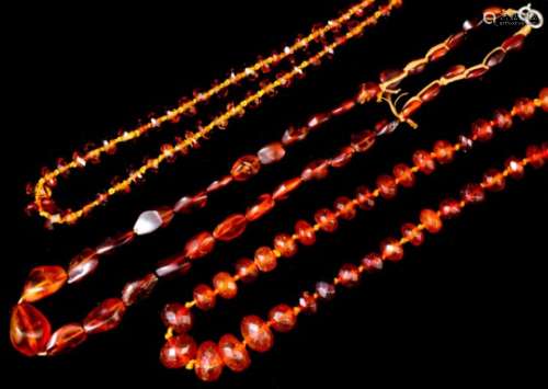 A single strand of thirty-six European reconstituted amber beads of oval form, 550mm overall (