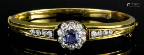 A modern Continental 18ct gold mounted sapphire and diamond stiff bracelet, set with a central