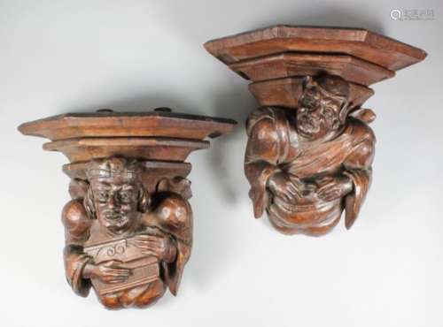 A pair of French oak corbels carved as a corpulent male figure wearing close fitting cap, and a male
